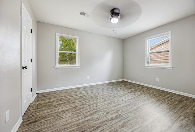 Empty room with wood finished floors and ceiling fan
