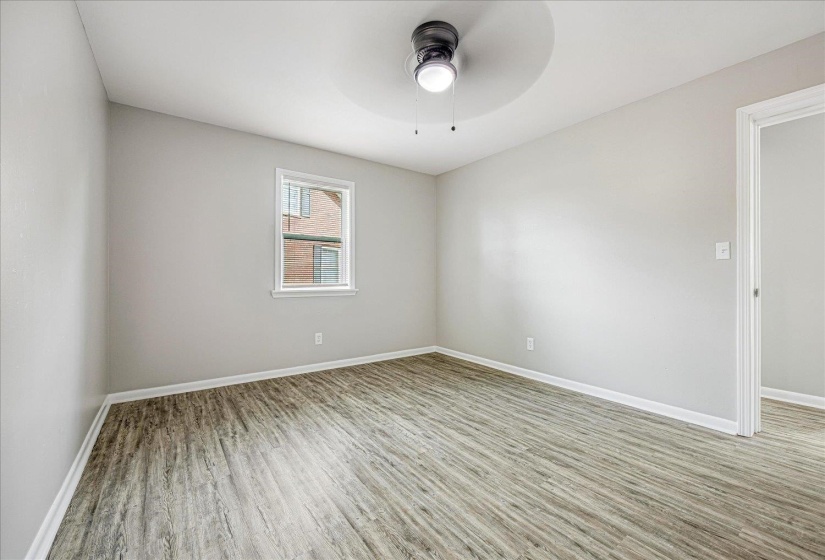 Empty room with light wood-type flooring and ceiling fan