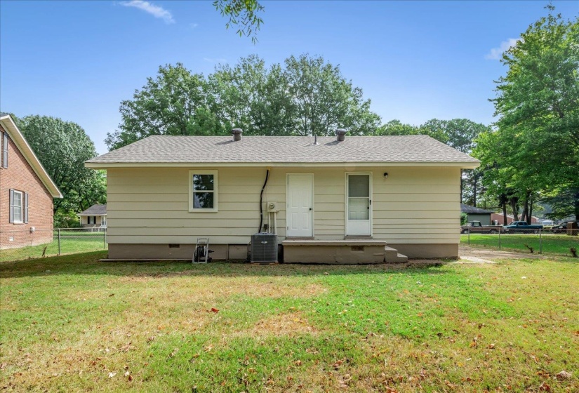 Rear view of house featuring roof with shingles and crawl space