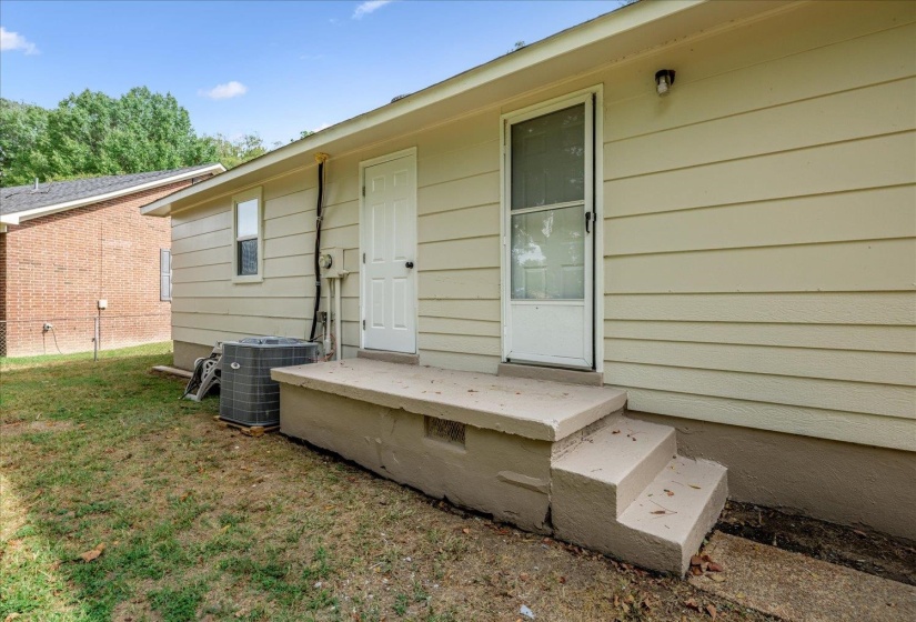 Doorway to property featuring a yard