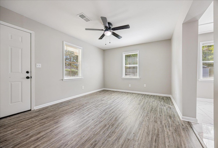 Unfurnished room with wood finished floors and a ceiling fan