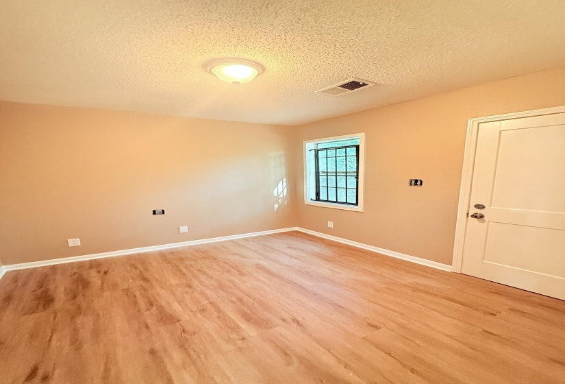 Spare room featuring a textured ceiling and light wood-type flooring