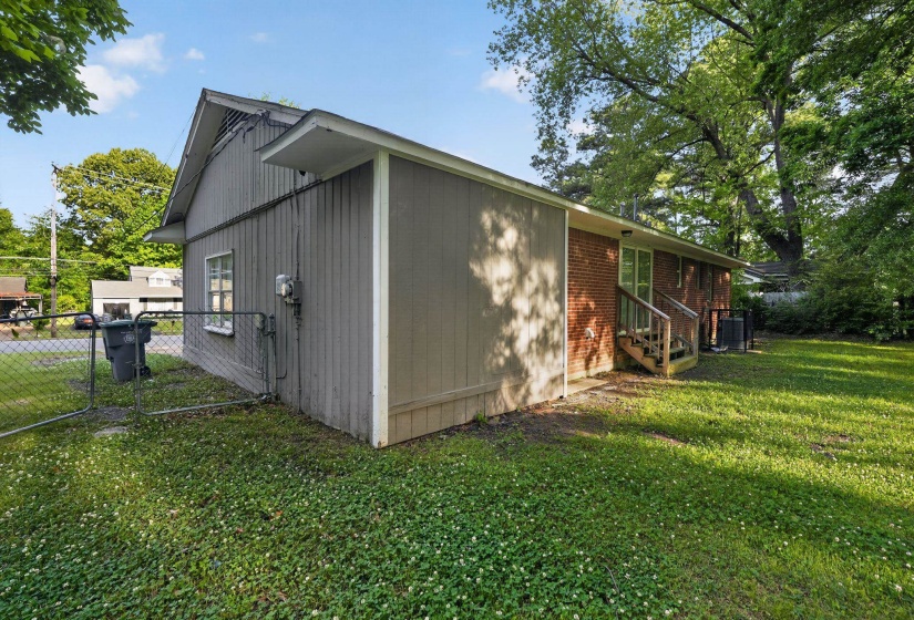 Expansive grassy yard with mature trees