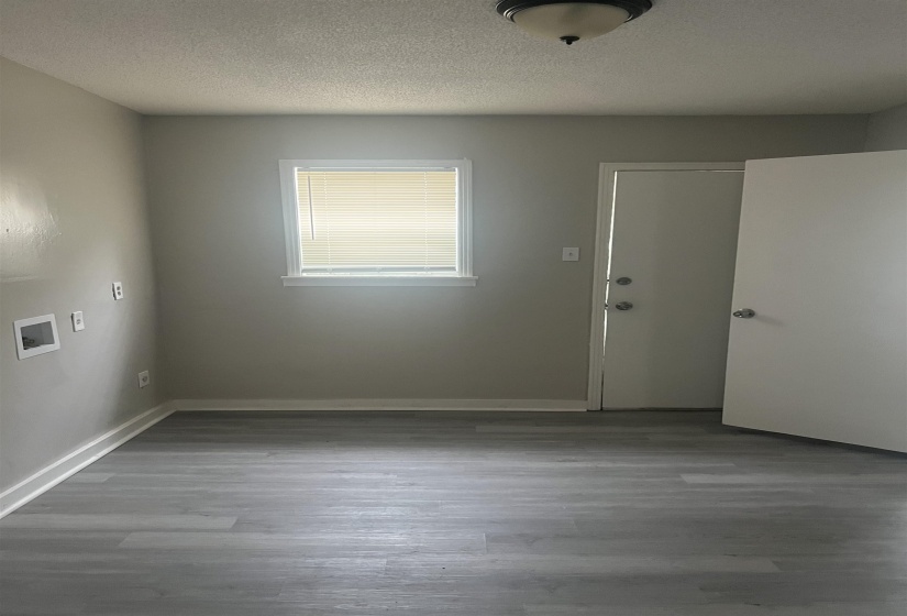 Spare room with a textured ceiling and wood finished floors