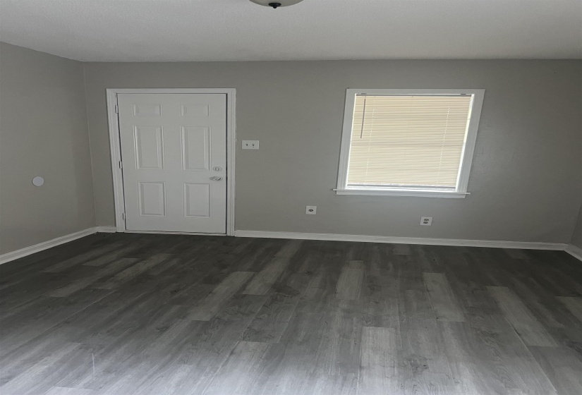 Entrance foyer with baseboards and dark wood-type flooring
