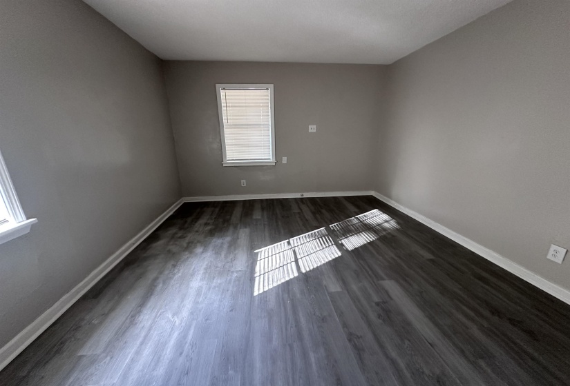 Empty room with baseboards and dark wood finished floors