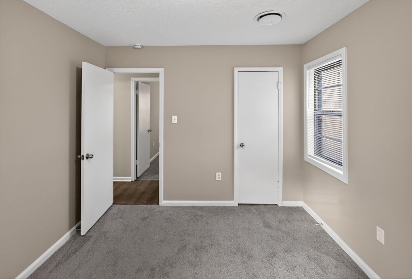 Unfurnished bedroom with carpet and baseboards