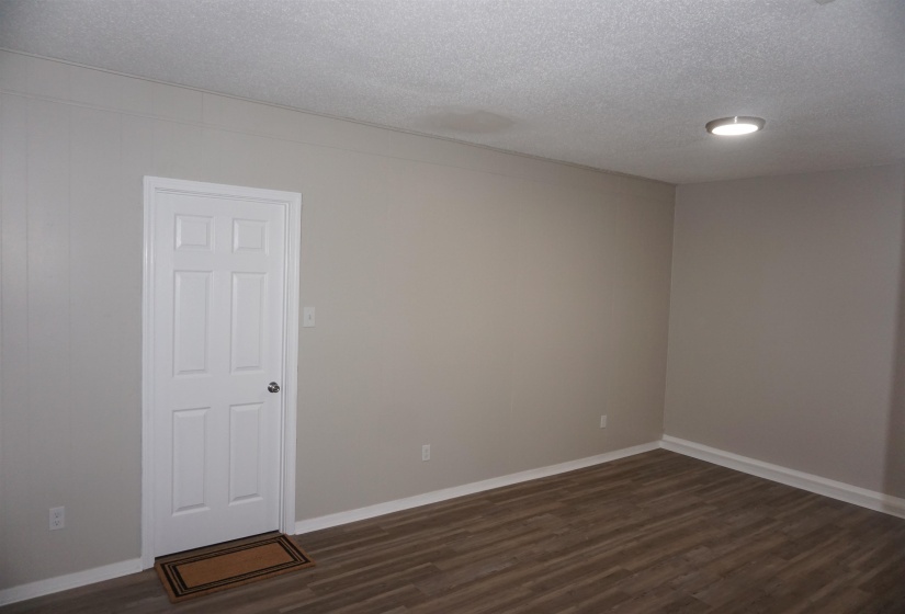 Neutral-toned walls with white trim and a six-panel door