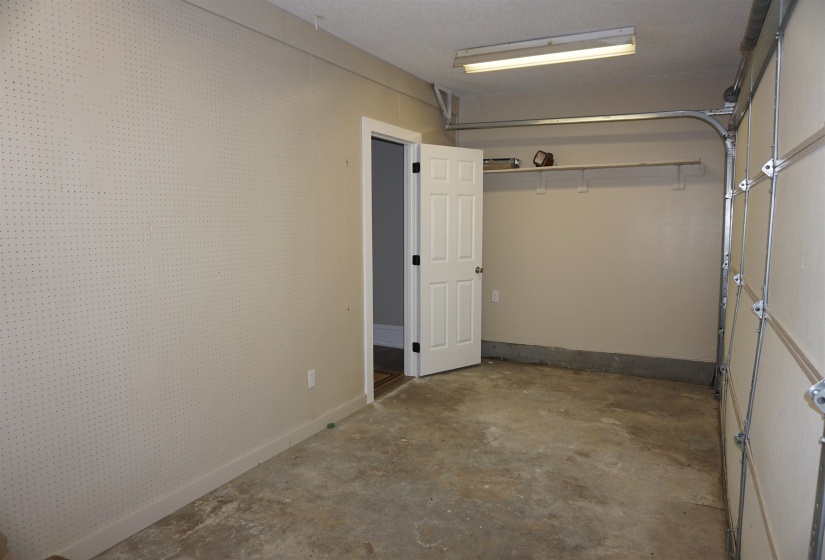 Single-car garage with concrete flooring