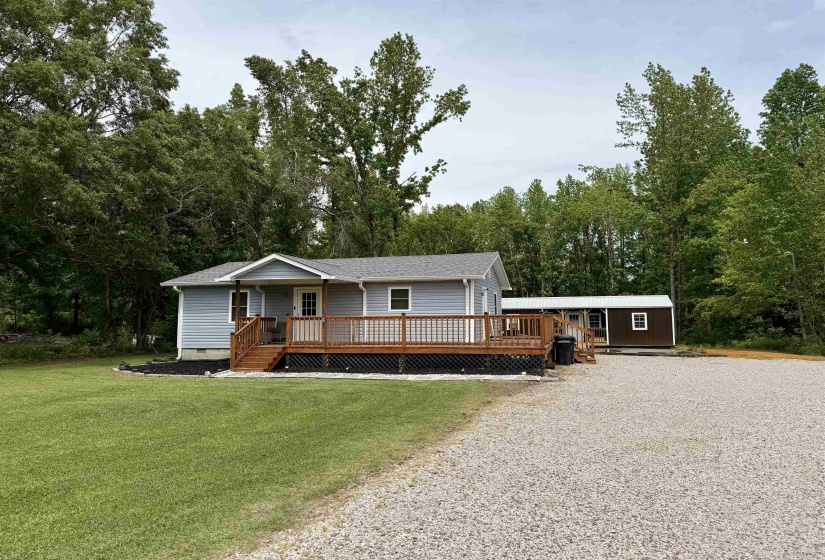Light blue siding exterior with a dark gray shingle roof