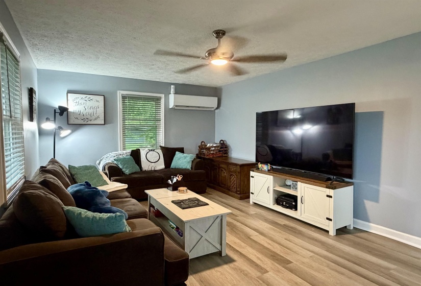 Living area featuring wood-finish flooring and light blue walls