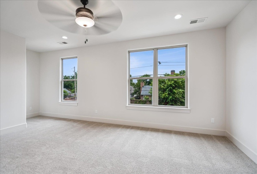 Room featuring two large windows, light gray carpeting, recessed lighting, a ceiling fan, and white baseboards