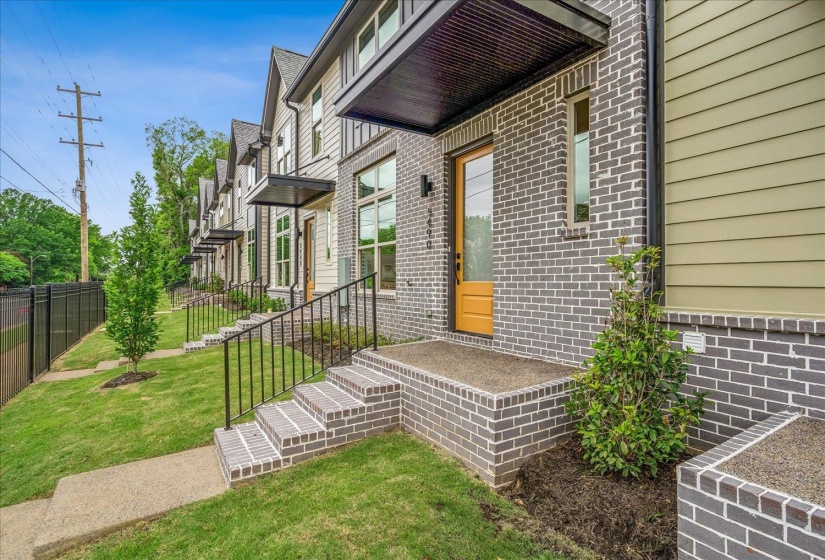 Contemporary townhome exterior featuring gray brick and horizontal siding