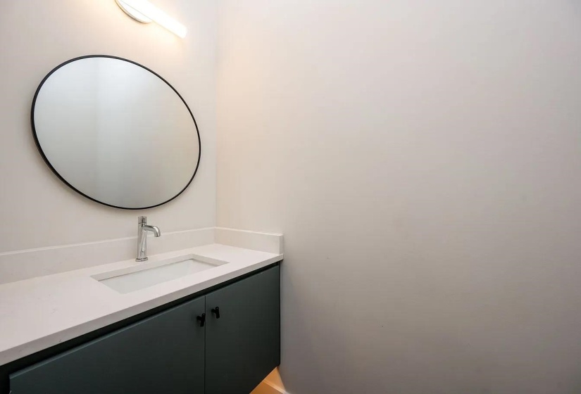 Modern bathroom vanity with a white countertop and integrated rectangular sink