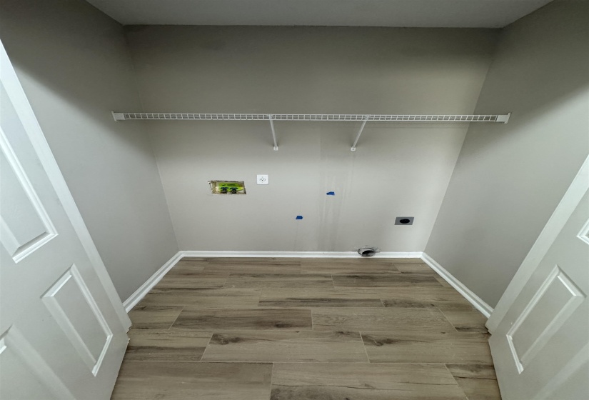Laundry room featuring light wood finished floors, washer hookup, and hookup for an electric dryer