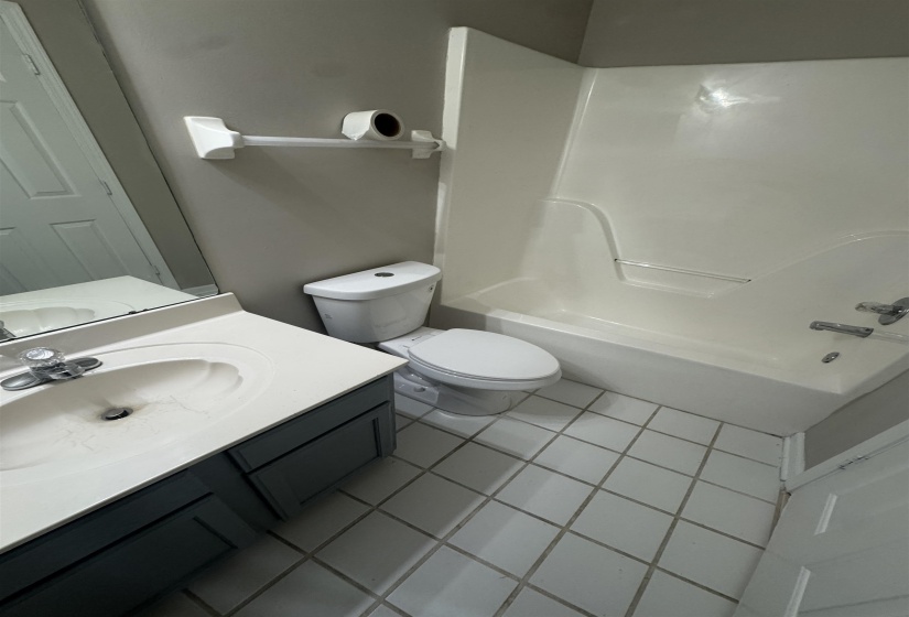 Bathroom featuring vanity, light tile patterned floors, and shower / bath combination