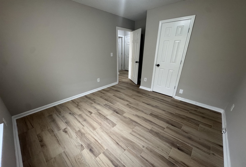 Unfurnished bedroom featuring light wood-style flooring and a closet
