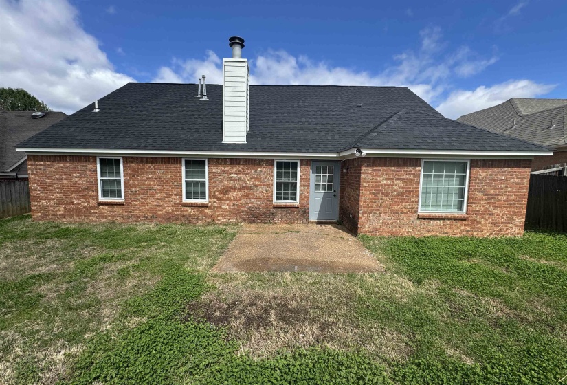 Back of property with a patio area, a chimney, a fenced backyard, and brick siding