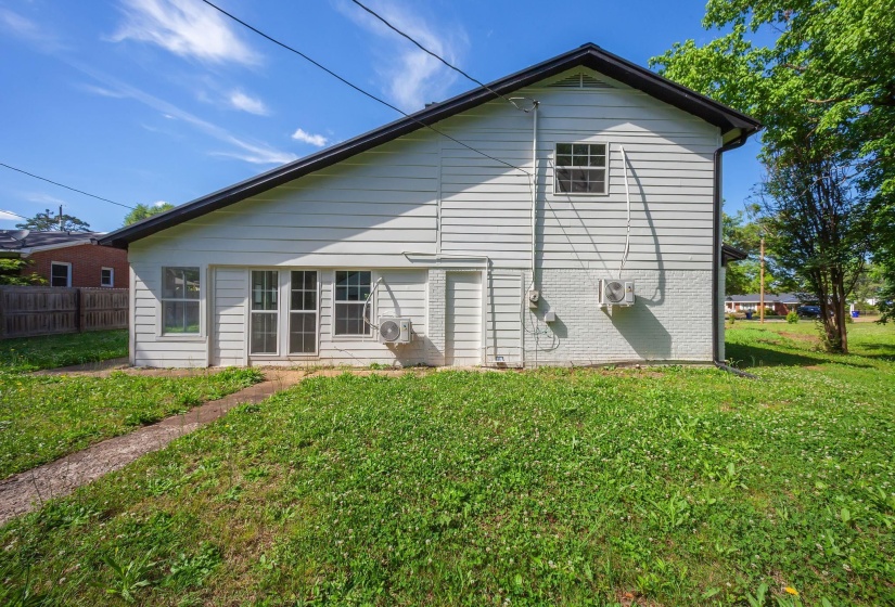 White siding exterior with a dark-pitched roofline