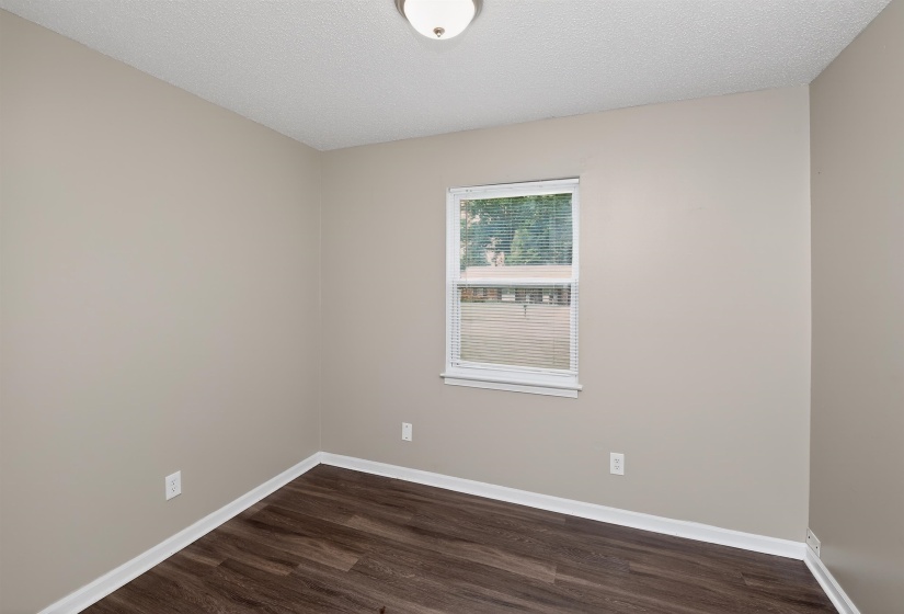 Neutral tone wall finishes with wood-finish flooring