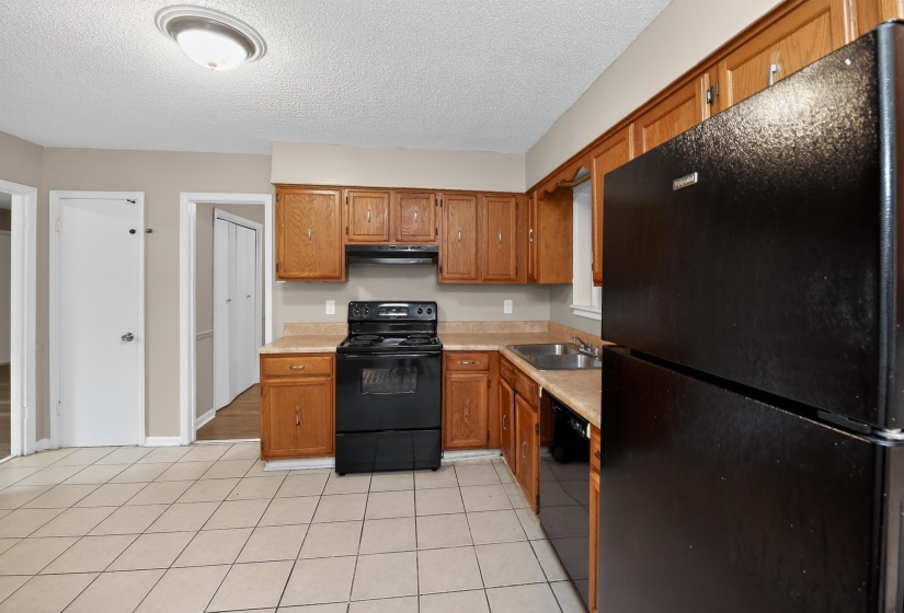 Kitchen featuring wood cabinetry and black appliances