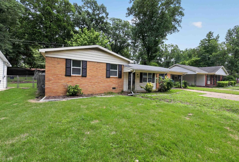 Brick and siding exterior featuring a covered entry and attached carport