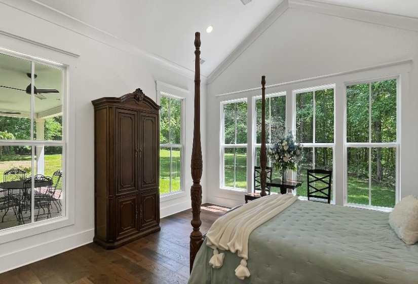 Spacious interior featuring a vaulted ceiling, recessed lighting, and rich wood-finish flooring
