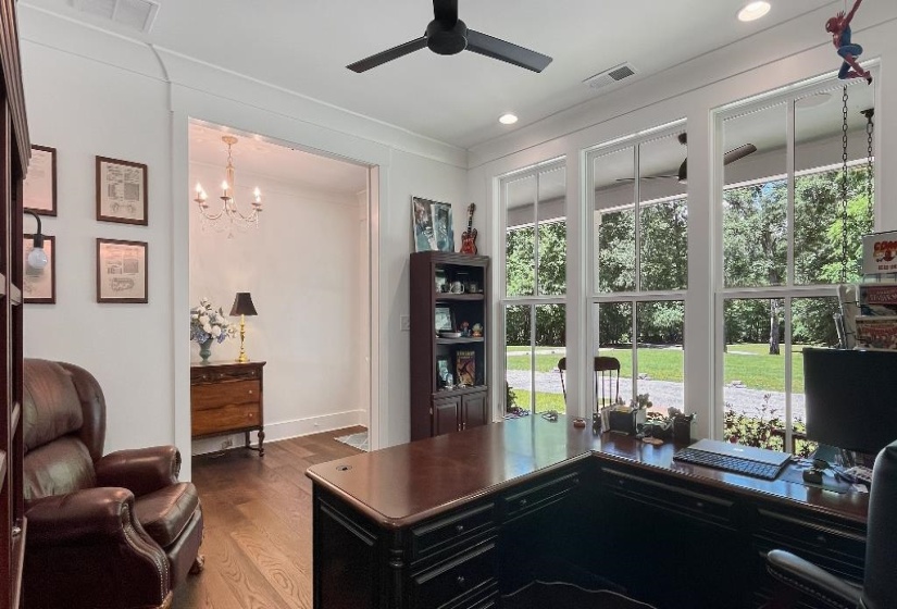Bright interior space featuring multiple windows, dark wood-finish flooring, recessed lighting, and a modern ceiling fan