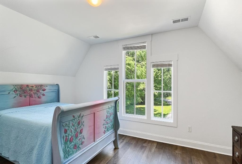 Room featuring wood-finish flooring, crisp white walls, and a recessed ceiling light fixture