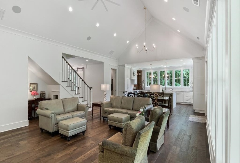 Spacious living area featuring high vaulted ceilings, recessed lighting, and rich wood-finish flooring