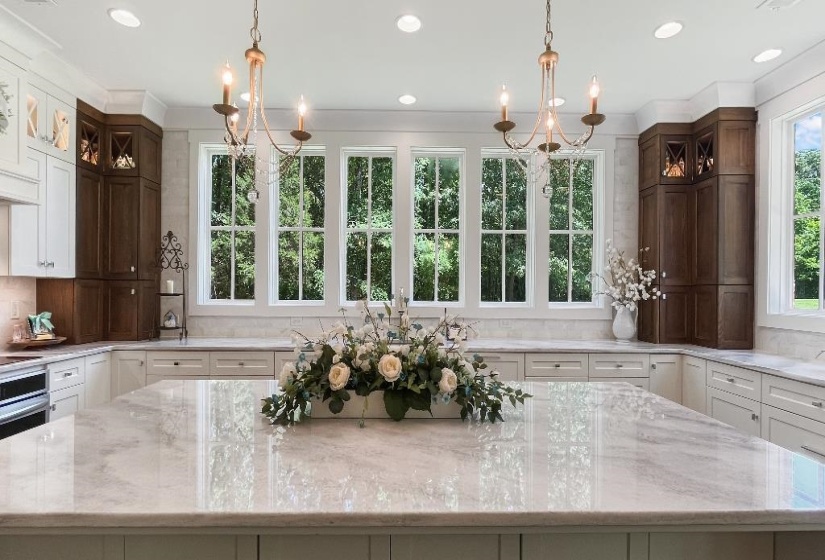 Spacious kitchen featuring a large central island with a stone surface