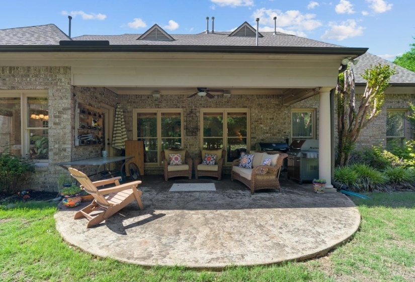 Covered patio featuring a stamped concrete surface, brick exterior, and recessed lighting