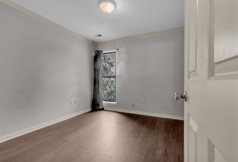 Neutral gray walls with white crown molding and baseboards