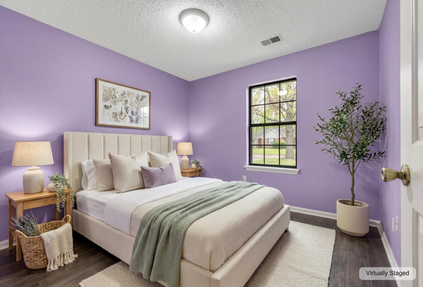 Bedroom featuring dark wood-finish flooring, a contemporary ceiling light fixture, a window with black trim, and light purple wall color