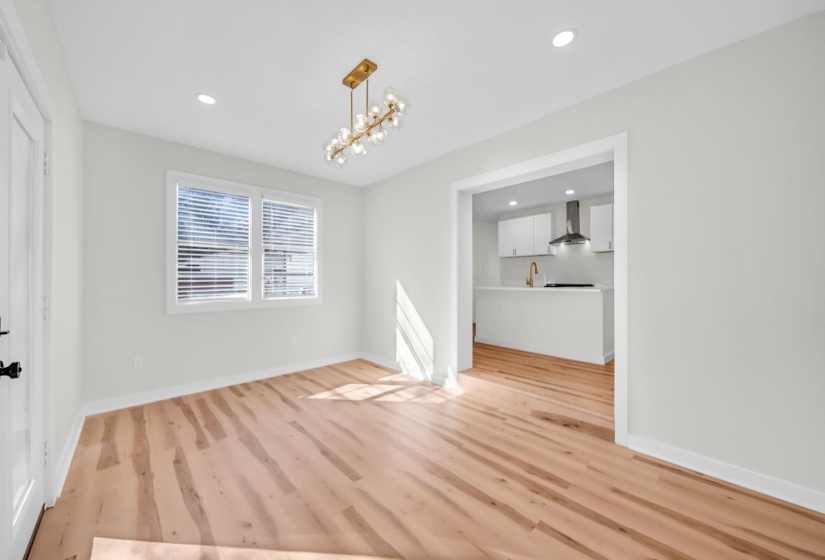 Unfurnished dining area featuring a chandelier, light wood-style floors, and recessed lighting