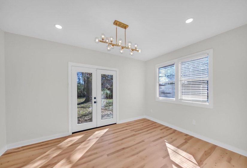 Unfurnished dining area featuring french doors, light wood-style floors, and recessed lighting