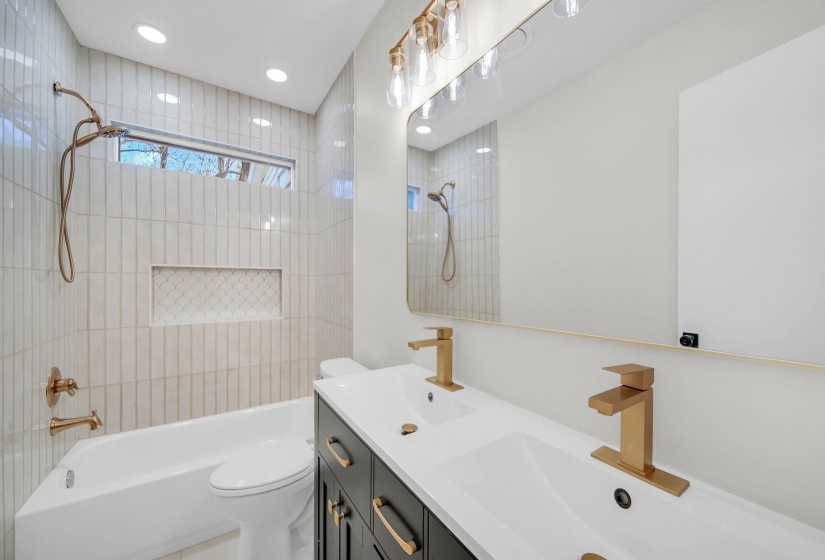 Full bathroom with double vanity, bathing tub / shower combination, and recessed lighting