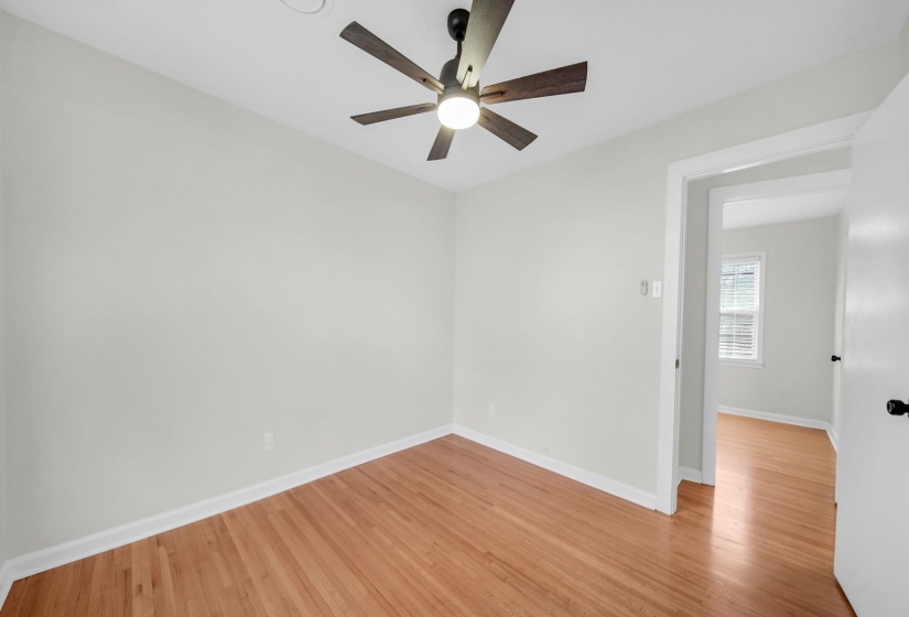 Unfurnished room featuring light wood finished floors and a ceiling fan
