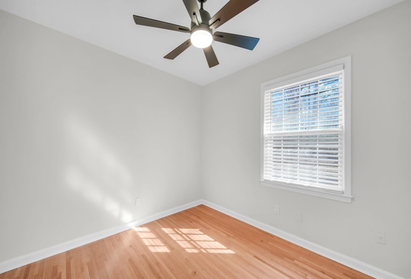 Spare room featuring light wood-type flooring and a ceiling fan