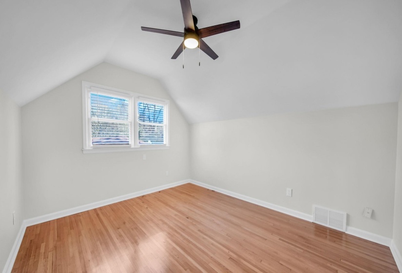 Bonus room featuring lofted ceiling, light wood finished floors, and a ceiling fan