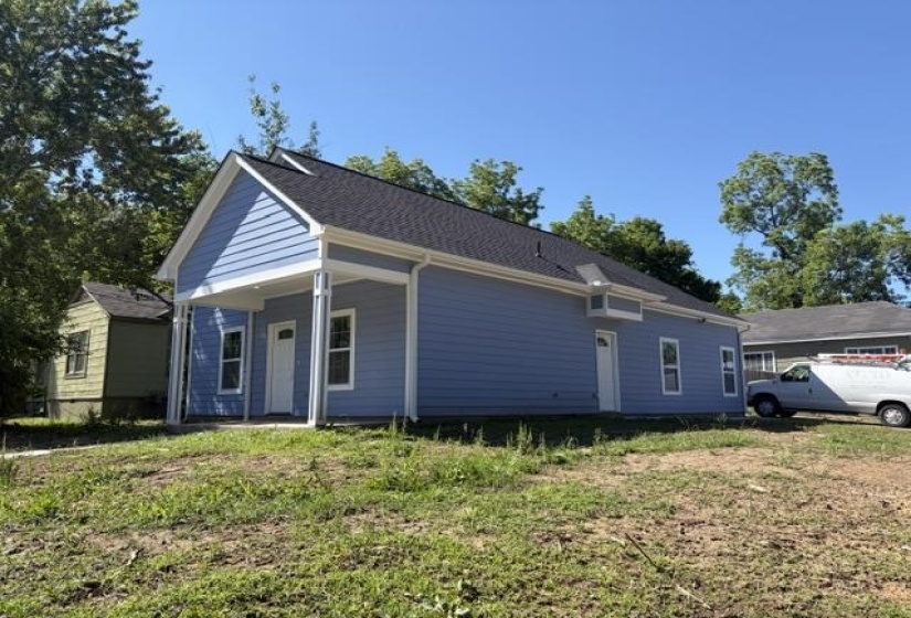 Light blue siding exterior with a dark shingle roof