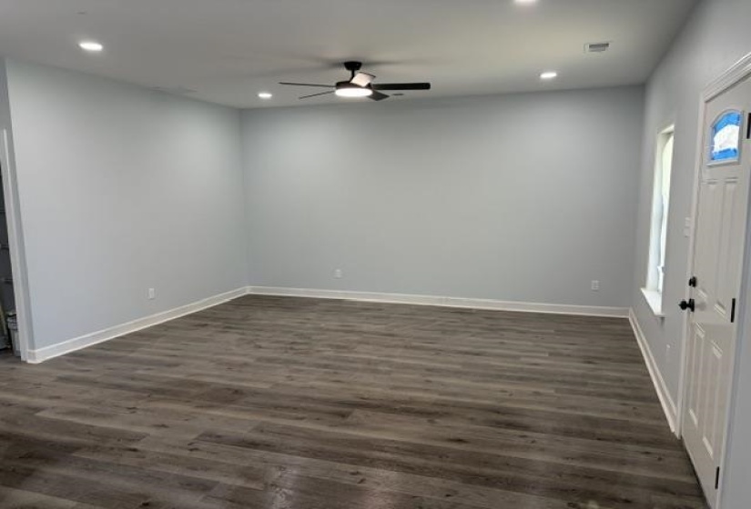 Open concept living space featuring wood-finish flooring, recessed lighting, and a ceiling fan