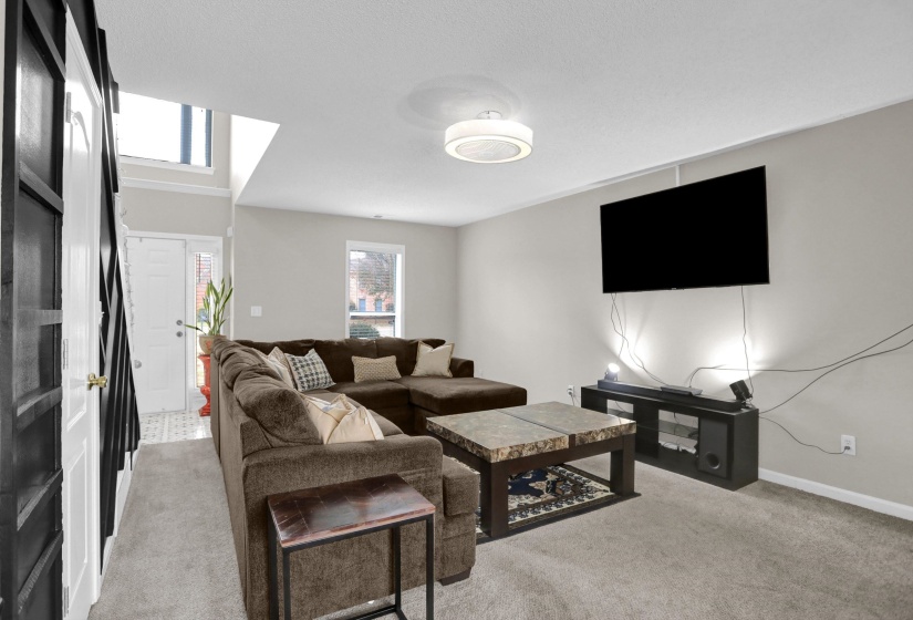 Living area with light colored carpet