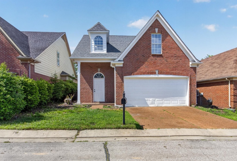Brick exterior with an attached two-car garage