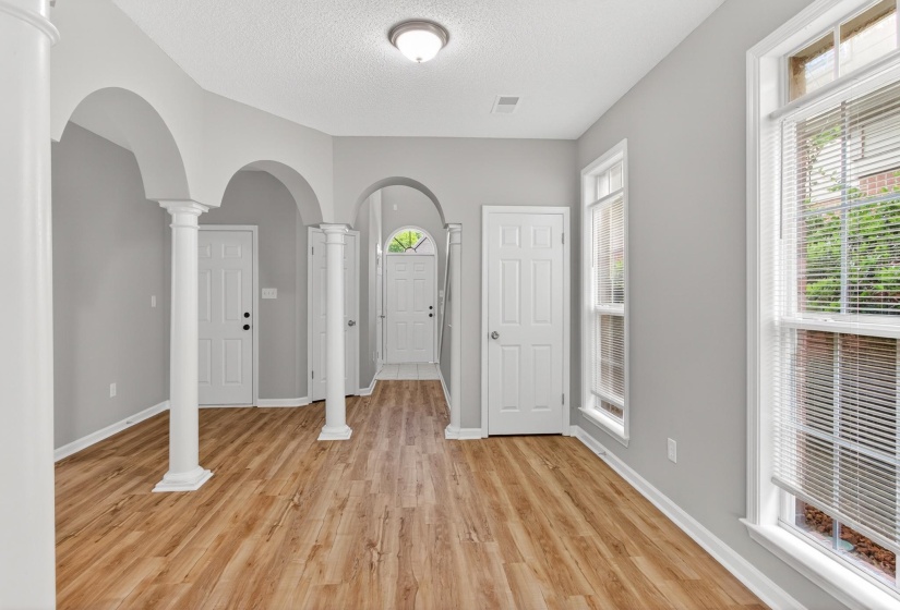 Interior space featuring wood-finish flooring, light gray wall tones, and white trim