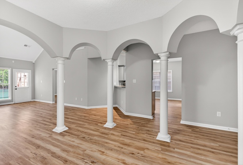 Open concept living space featuring wood-finish flooring and light gray walls