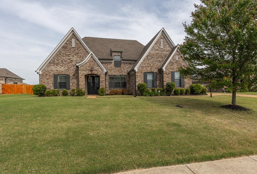 Classic brick exterior with gabled roof lines and dark shutters