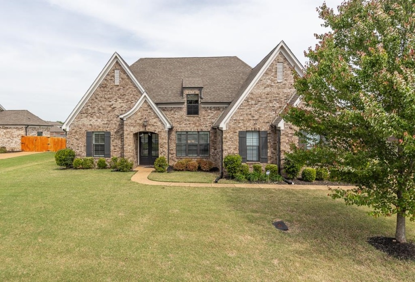 Brick veneer exterior with gabled roof lines and dark shutters
