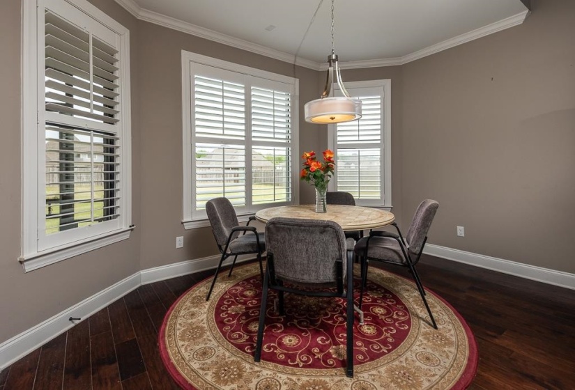 Dark wood-finish flooring complemented by a neutral wall color and white trim
