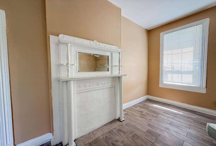 Decorative fireplace mantel with ornate carvings and an integrated mirror